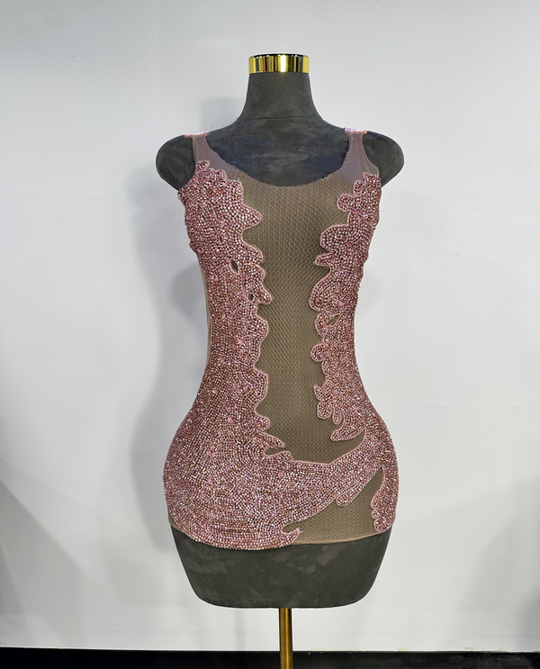 Luxury pink rhinestone dress by Bell Couture on mannequin against plain wall