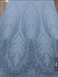 Close-up of Angel Gown fabric swatch, powder blue beaded feather pattern with crystal embellishment