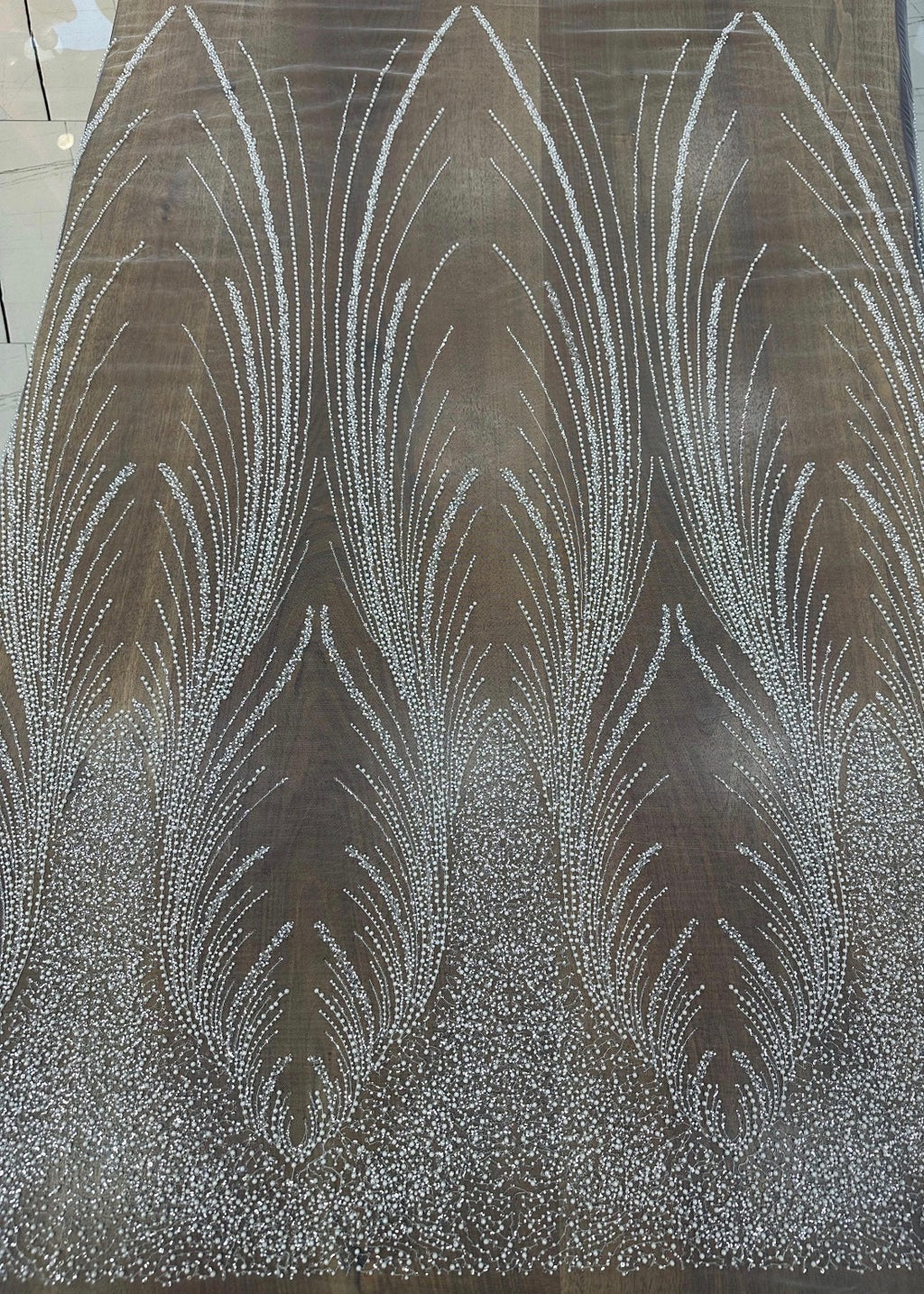 Close-up of Angel Gown fabric swatch in bronze, beaded feather pattern colorway option