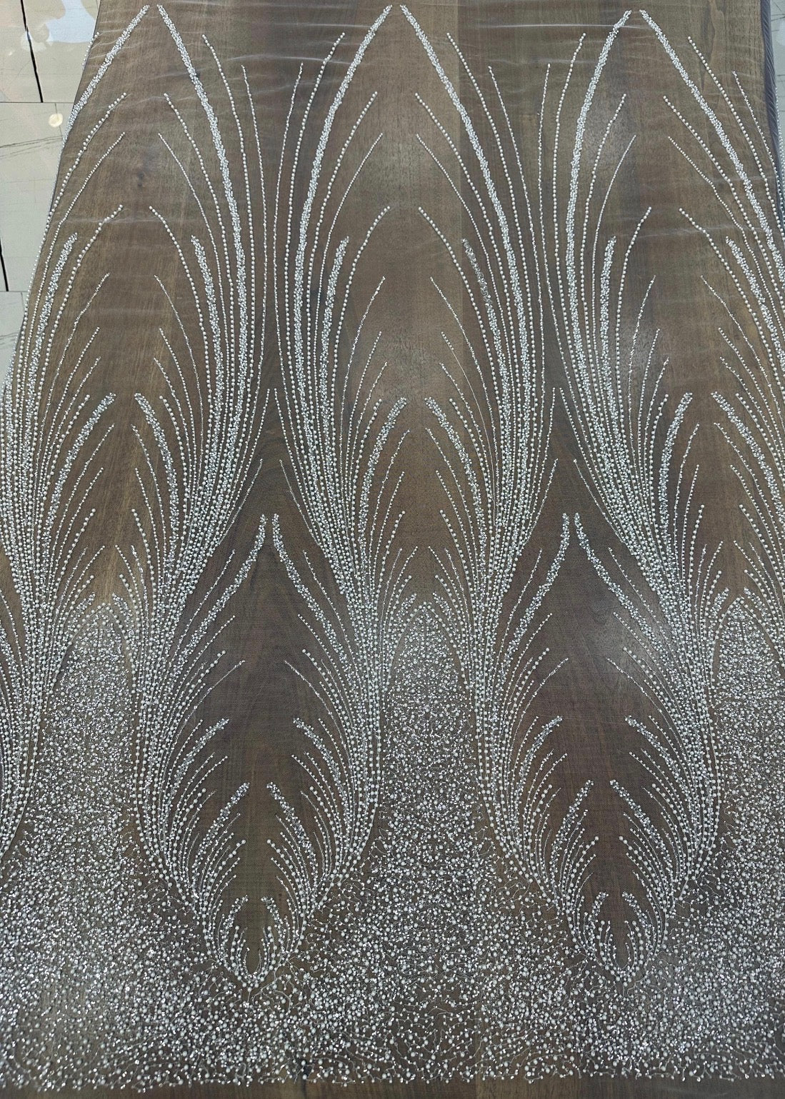 Close-up of Angel Gown fabric swatch in bronze, beaded feather pattern colorway option