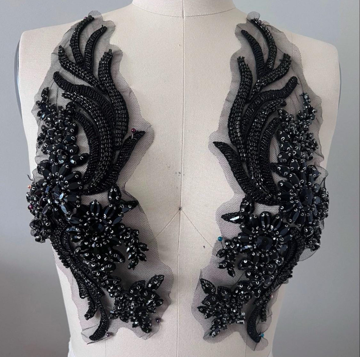 Black beaded embroidery patches on a mannequin