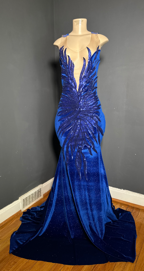 A royal blue glitter velvet gown with a V-neck front and flame sequin applique, featuring a mermaid train by Bellz Couture in Detroit.